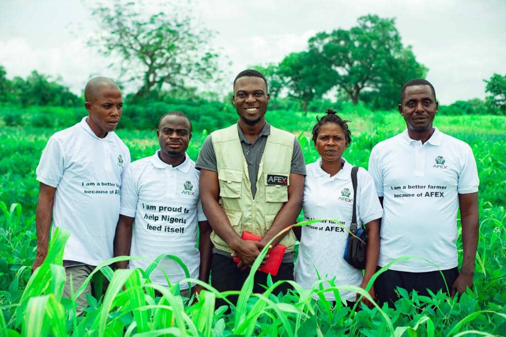 Emmy with farmers in a green field
